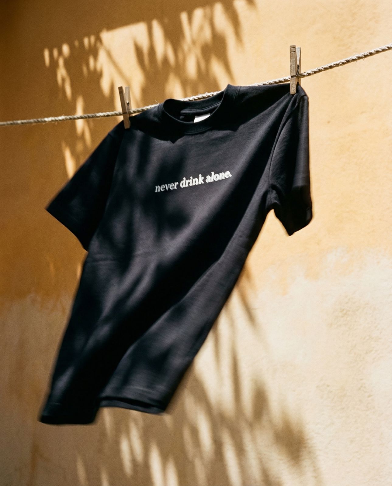 NEVER DRINK ALONE TEE