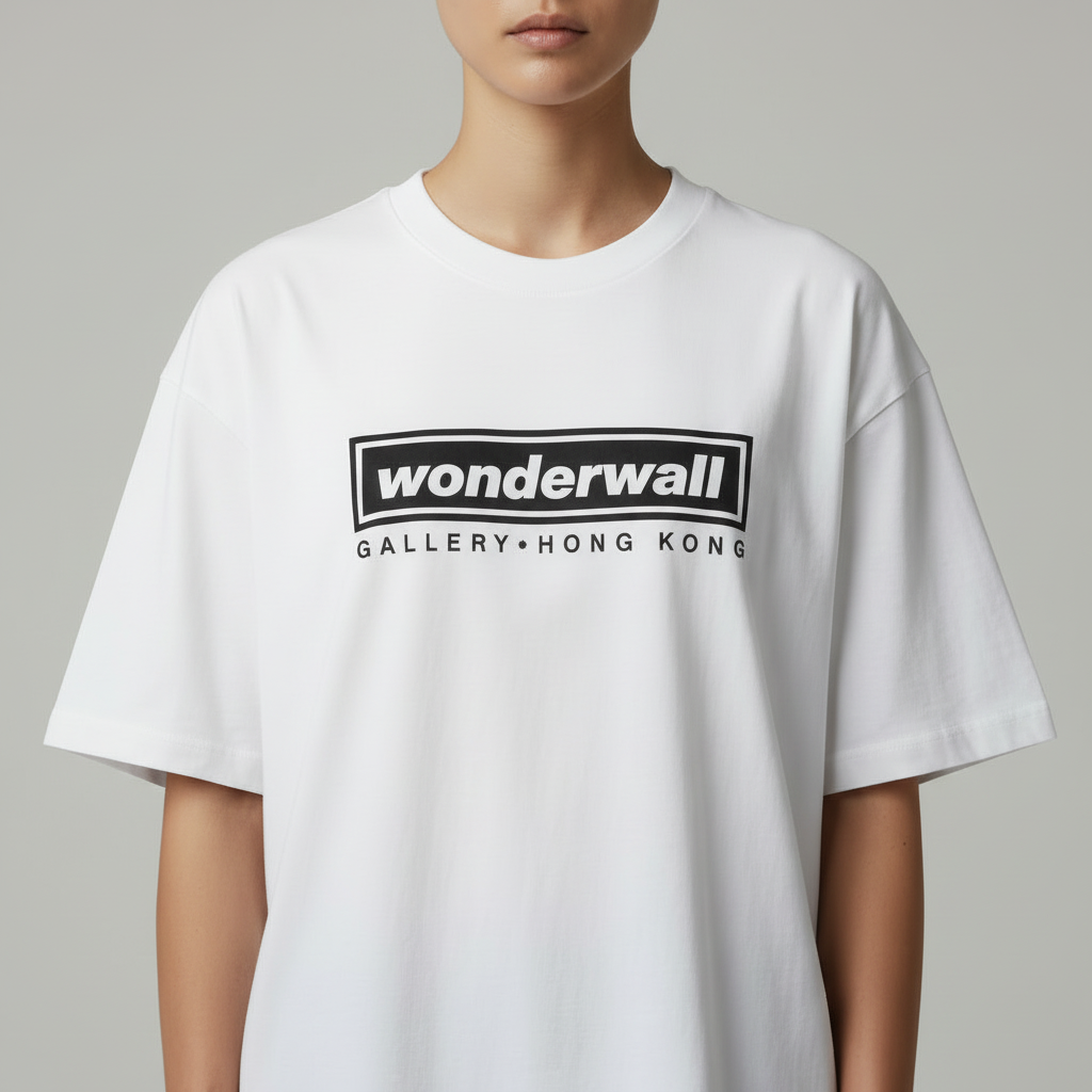 White t-shirt with 'wonderwall' logo worn by a person on a gray background